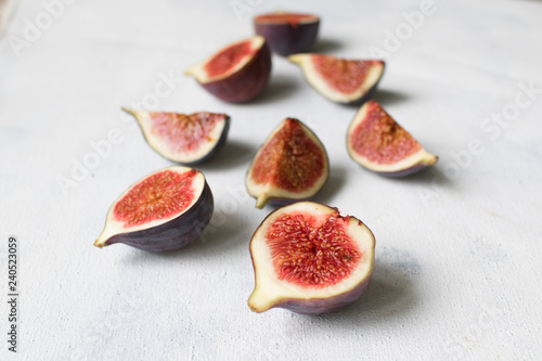 Fresh fig. Fruit with half and quarter on light background. Collection.