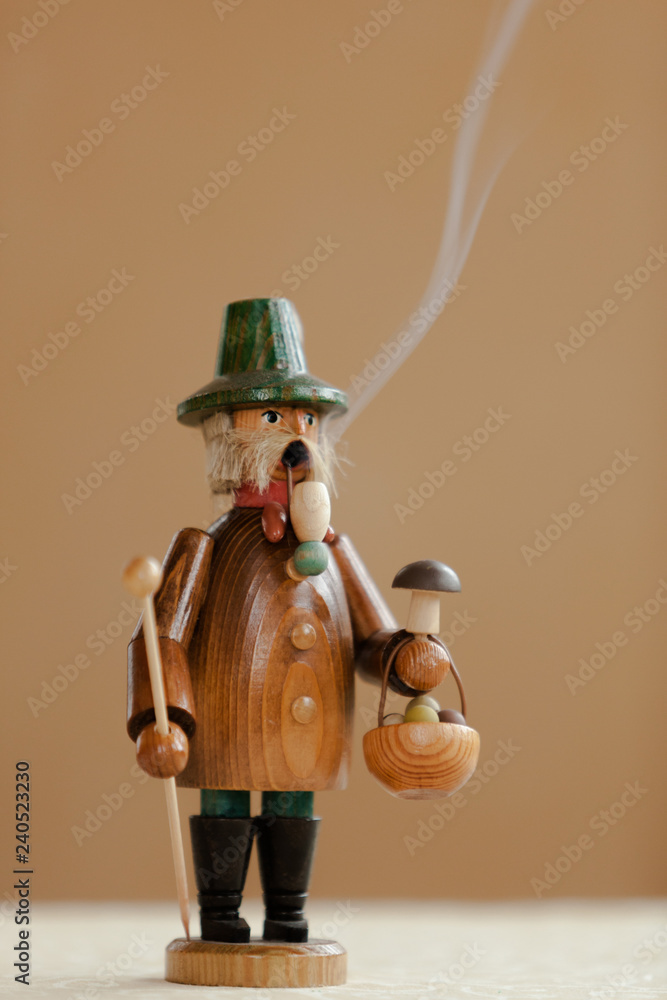 A hand-made Smoker Figurine, traditional German Christmas Decoration from the Erzgebirge Region in Eastern Germany A hand-made Smoker Figurine, traditional German Christmas Decoration from the Erzgebirge Region in Eastern Germany