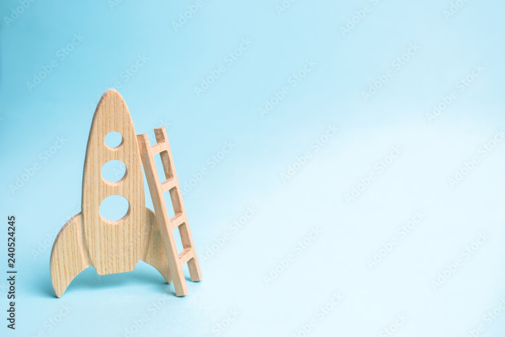 Rocket and ladder on a blue background. The rocket is ready to take off into space. The concept of a startup, education and the desire to research. Space tourism, flight to the moon or mars Rocket and ladder on a blue background. The rocket is ready to take off into space. The concept of a startup, education and the desire to research. Space tourism, flight to the moon or mars