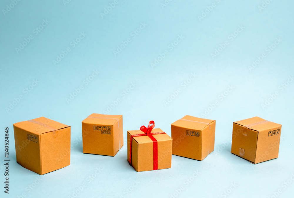 Fototapeta premium A gift box lies among other boxes. The concept of selling goods and services, buying gifts for birthday and new year, Christmas. The right choice of gift, advertising products and services, marketing
