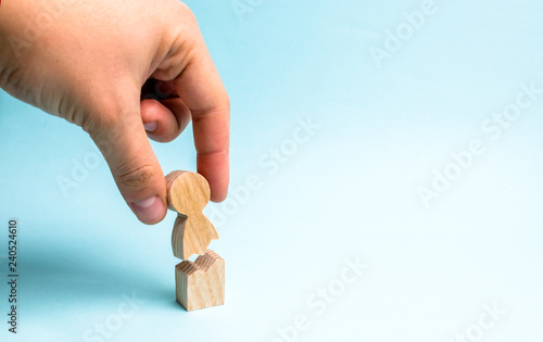 Fotografie The hand of the person collects a figure of the person together