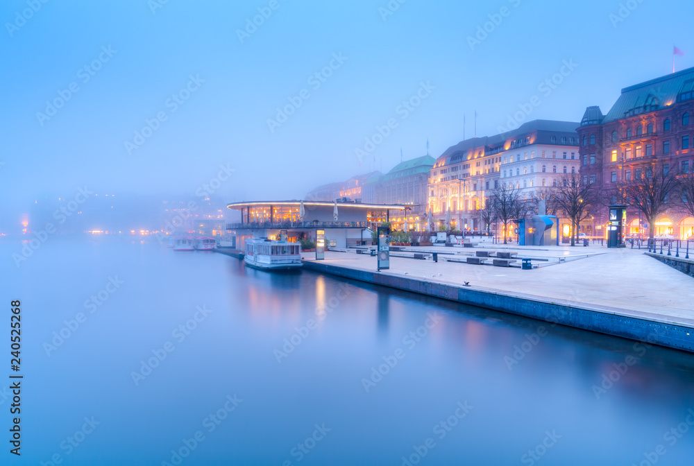 The lake Inner Alster (German: Binnenalster) and downtown in Hamburg, Germany, in the fog.