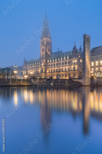 The City Hall (Rathaus) of Hamburg, Germany, in the fog at dusk.