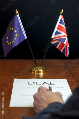 Brexit Concept.  Male Hand From Rear Signing Sheet of Paper Headed 