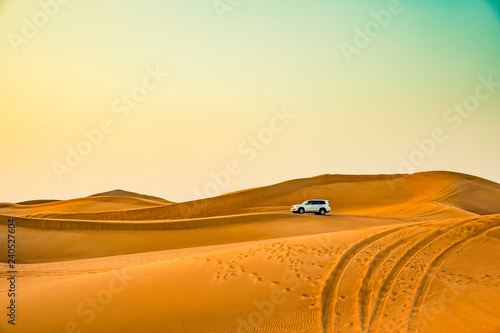 Jeep riding on sand at the desert with dunes