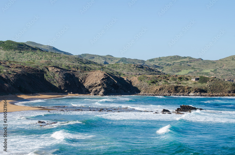 Landscape photography of one of the coasts of Menorca with red earth and blue sea in winter Landscape photography of one of the coasts of Menorca with red earth and blue sea in winter