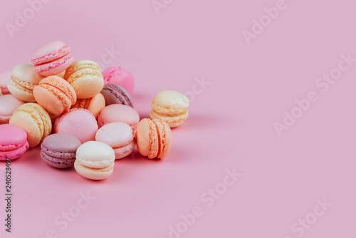 Sweet french macarons on pink background.