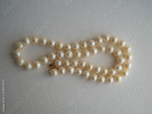 Pearl necklace on paper