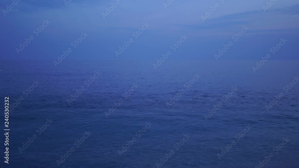 Dark blue evening peaceful sea and sky background. Beautiful moody marine landscape with copyspace. Real time 4k video footage. Dark blue evening peaceful sea and sky background. Beautiful moody marine landscape with copyspace. Real time 4k video footage.
