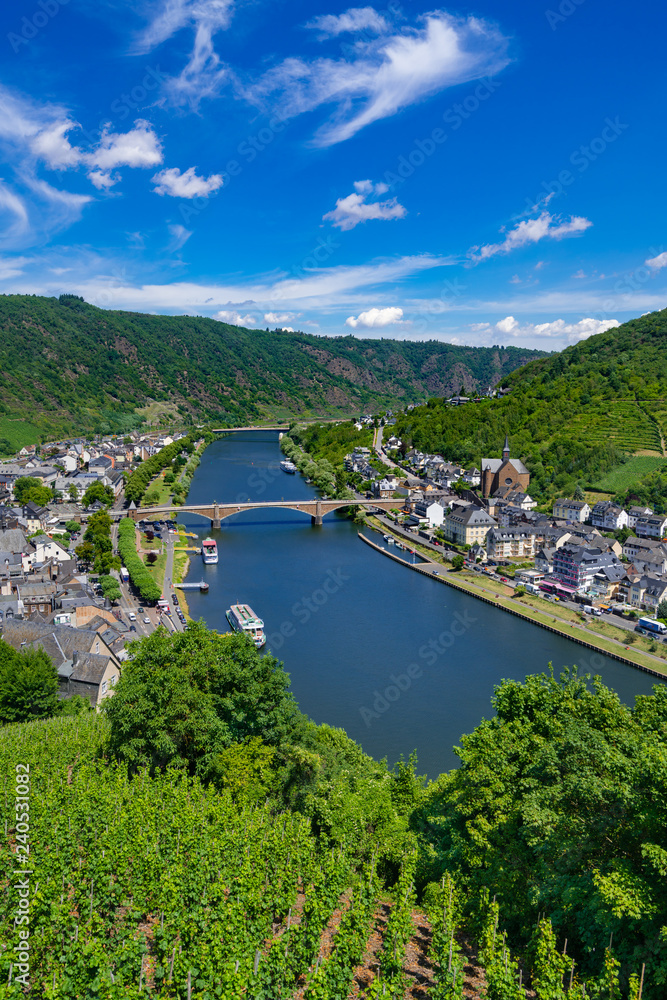 Fototapeta premium The town of Cochem, Germany, in the summer. It lies in the most romantic part of the Moselle Valley, where the river curves between two hiking paradises - Eifel and Hunsrück.