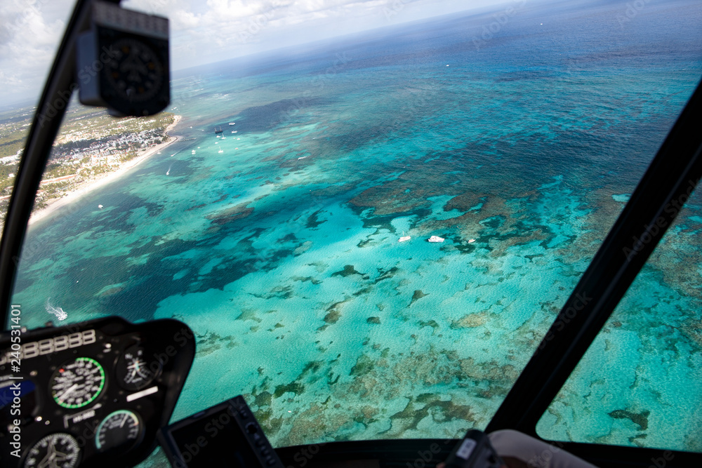 Obraz premium View from the cabin of the helicopter on the coast of the Dominican Republic