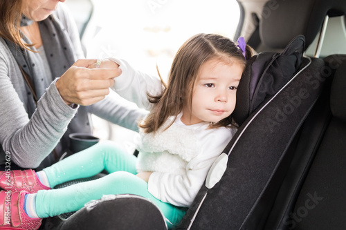 Woman Taking Precautions For Daughter In Car