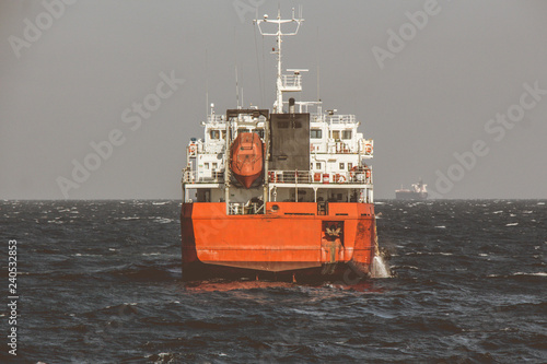 cargo ship sailing in still water