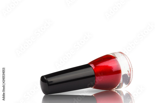 bottle of red lacquer isolate on white background, with mirror surface reflection