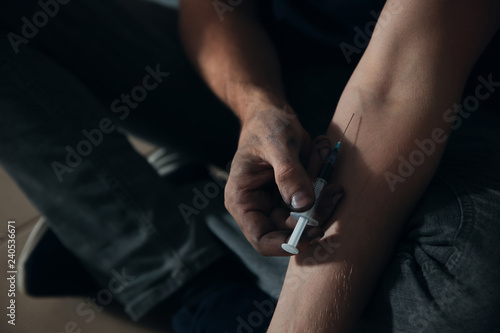 Male drug addict making injection, closeup of hands