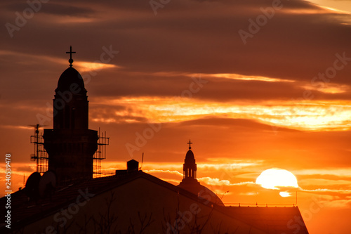 Church towers silhouette in stunning sunset 