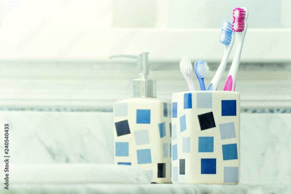Toothbrushes and toothpaste in a bathroom for denral hygiene and care. Empty copy space for Editor's text Toothbrushes and toothpaste in a bathroom for denral hygiene and care. Empty copy space for Editor's text