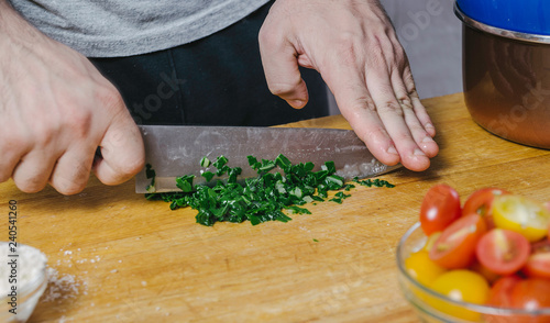 Chef's hands cutting mangold leaves