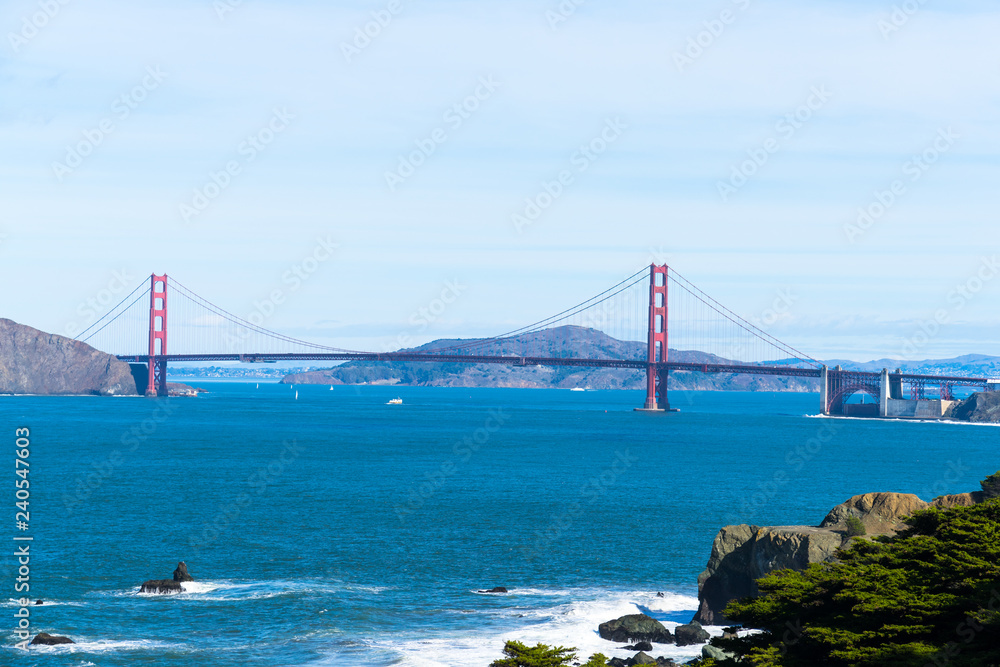 The view of golden gate bridge in Lands end at San Francisco- San Francisco. summer , cloud , rock , sea, plant. The view of golden gate bridge in Lands end at San Francisco- San Francisco. summer , cloud , rock , sea, plant.