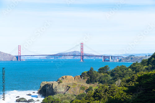 The view of golden gate bridge in Lands end at San Francisco- San Francisco. summer , cloud , rock , sea, plant.