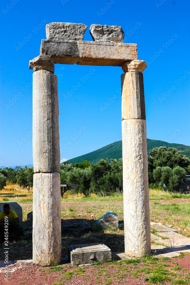 Ruins of ancient greek temple against a blue sky, ancient Messini, Greece
