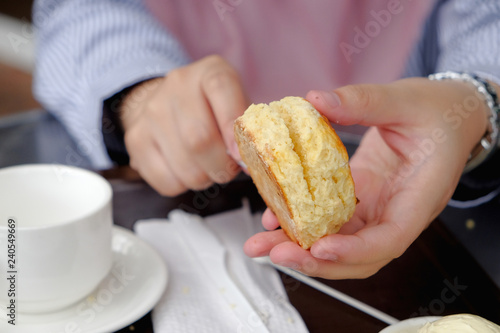 Фотография Young muslim woman eating delicious scone with strawberry jam and tea at the strawberry farm at Cameron Highland