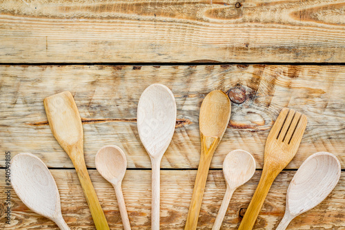 Fork, spoon in woodenware set on wooden background top view space for text