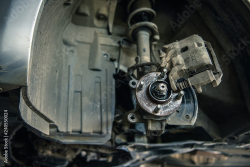 Car mechanics are replacing used brake discs.