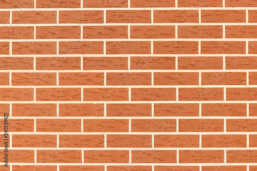 Wall of brown brick. The texture of the brickwork. Grunge background with space for text or image.