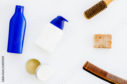 Instruments of male hairdresser with shampoo and comb in barbershop top view on white background mock up