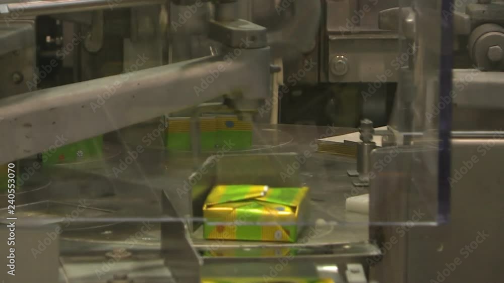 Production of butter at the dairy plant. The machine puts the oil in the bags and seals them Production of butter at the dairy plant. The machine puts the oil in the bags and seals them