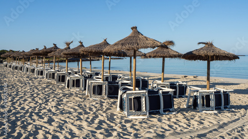 Colonia Sant Jordi  Mallorca  Spain. Beach with straw umbrellas and sunbeds in the morning without people