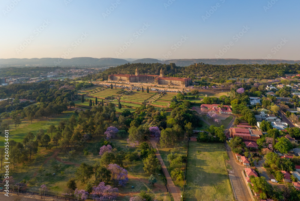Aerial view of The Union Buildings, government offices in Pretoria, South Africa showing beautiful, manicured gardens and some blooming Jacaranda trees.