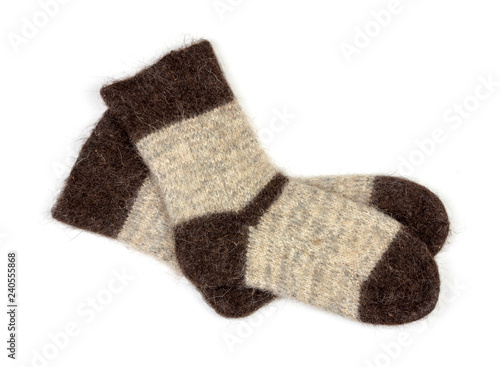 male grey knitted socks of dog fur on white background close-up, top view