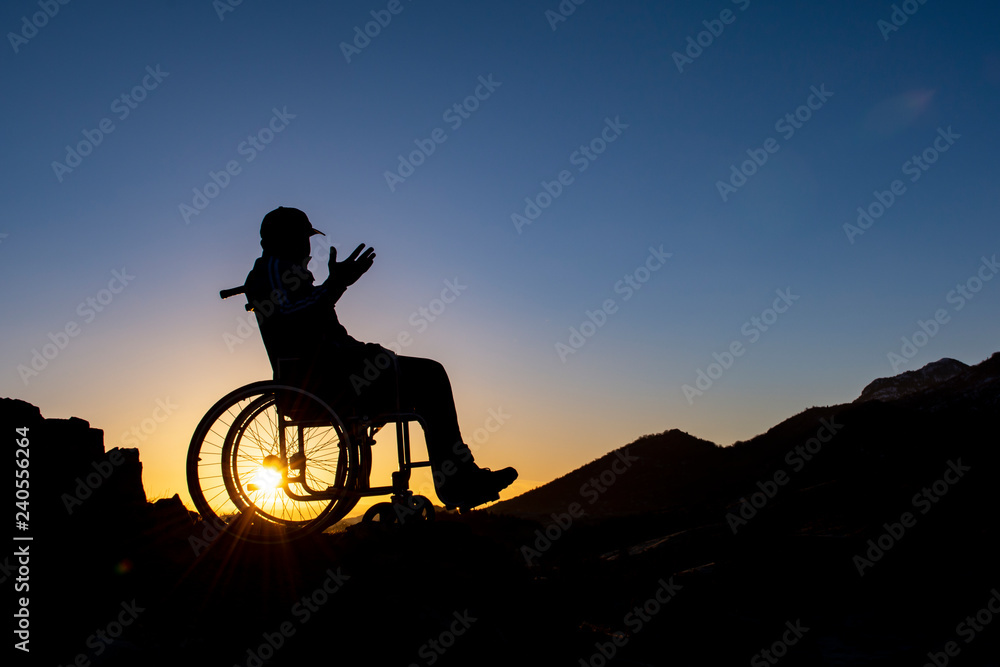man in wheelchair watching amazing sunrise man in wheelchair watching amazing sunrise