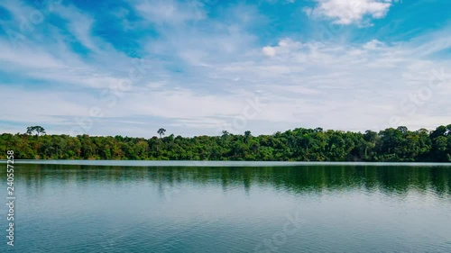 Time lapse: Banlung travel destination in Cambodia, volcanic crater lake Yeak Laom, natural park protected land, motion clouds over tropical reainforest photo