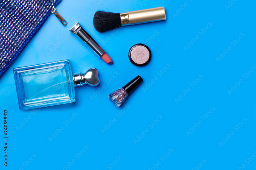 Cosmetic bag cosmetics perfume on blue background Cosmetic bag cosmetics perfume on blue background
