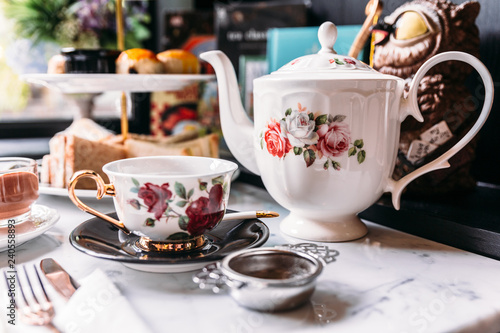 English Vintage Porcelain Roses Tea Sets including teapot, tea cup, plate, spoon and tea filter.