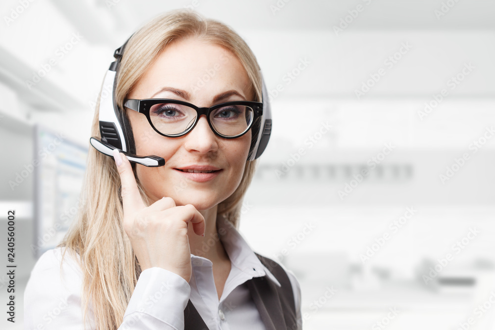 Three call center service operators at work. Portrait of smiling pretty female helpdesk employee with headset at workplace. Three call center service operators at work. Portrait of smiling pretty female helpdesk employee with headset at workplace.