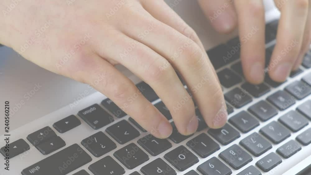 Businessman hands are typing a quarterly report on a laptop keyboard Businessman hands are typing a quarterly report on a laptop keyboard
