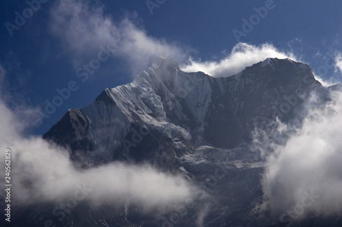 Snowy peaks in the clouds. Trekking to Annapurna Base Camp