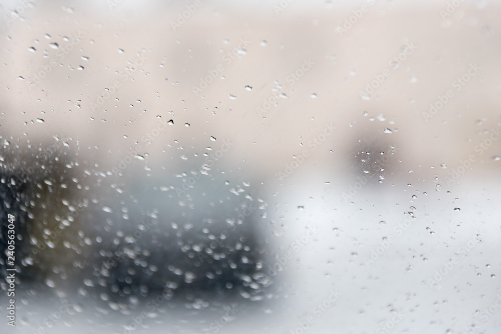 Drops on glass, a view from within of the city