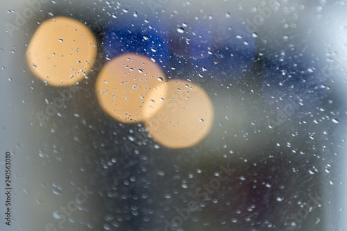 Drops on glass and the shining city fires - a soft background