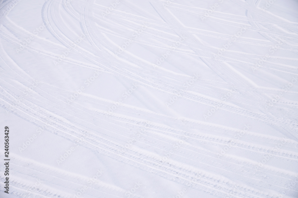 Obraz premium Traces of intersecting arcs of automobile tires in fresh snow