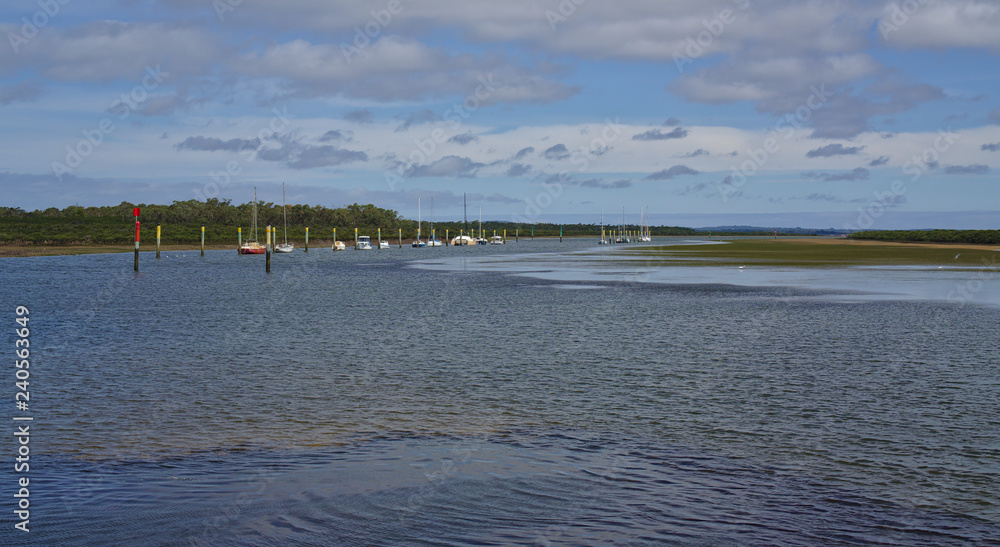 Distant view of moored boats on peaceful water