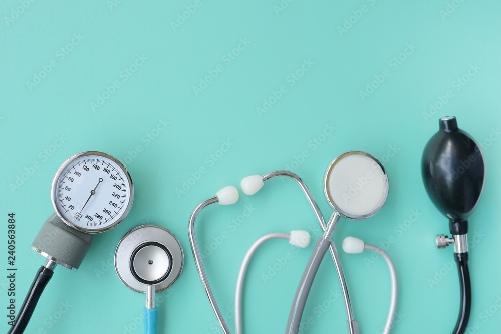 Blood pressure meter and stethoscope on blue background Blood pressure meter and stethoscope on blue background