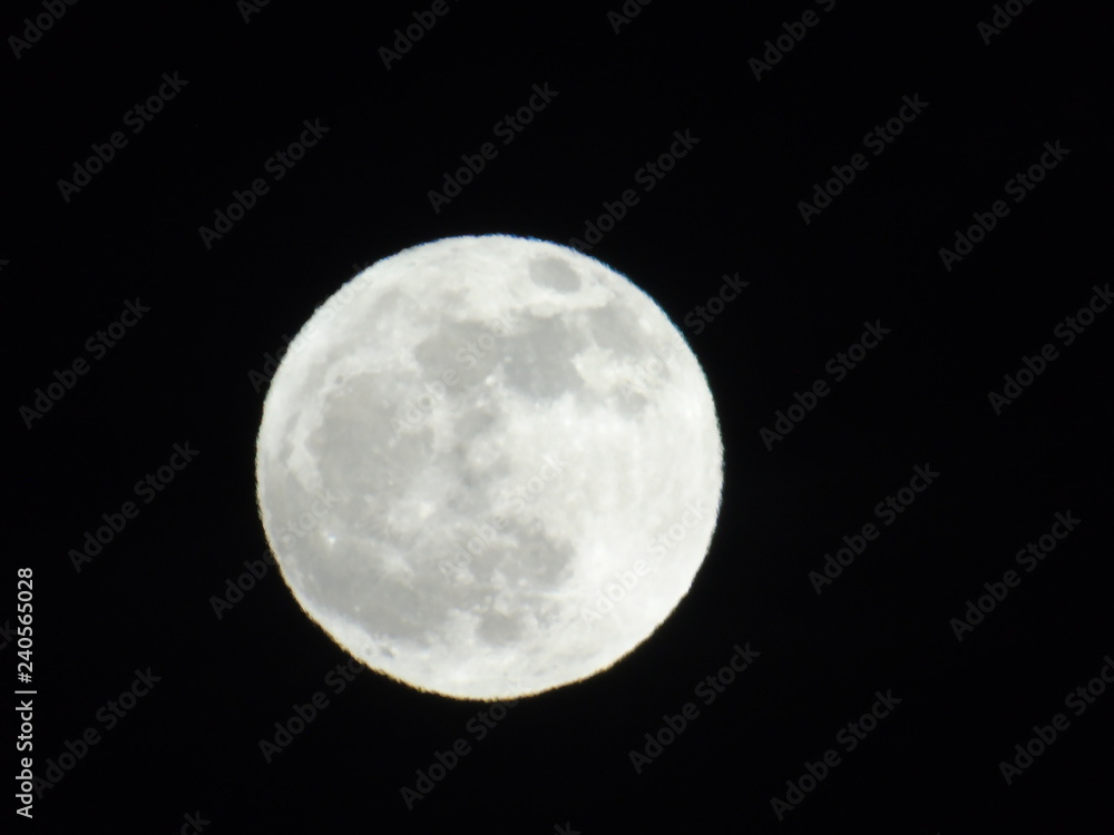 An amazing photography of the full moon over the city of Genova by night with a great clear sky in background and some stars An amazing photography of the full moon over the city of Genova by night with a great clear sky in background and some stars