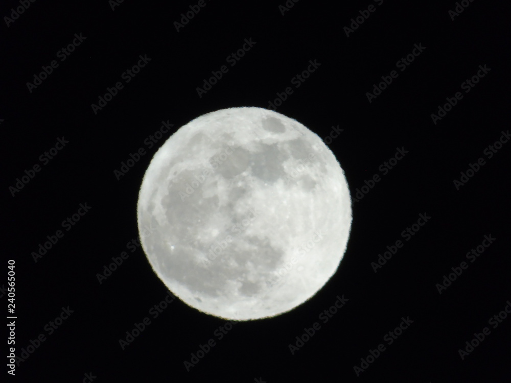 An amazing photography of the full moon over the city of Genova by night with a great clear sky in background and some stars An amazing photography of the full moon over the city of Genova by night with a great clear sky in background and some stars
