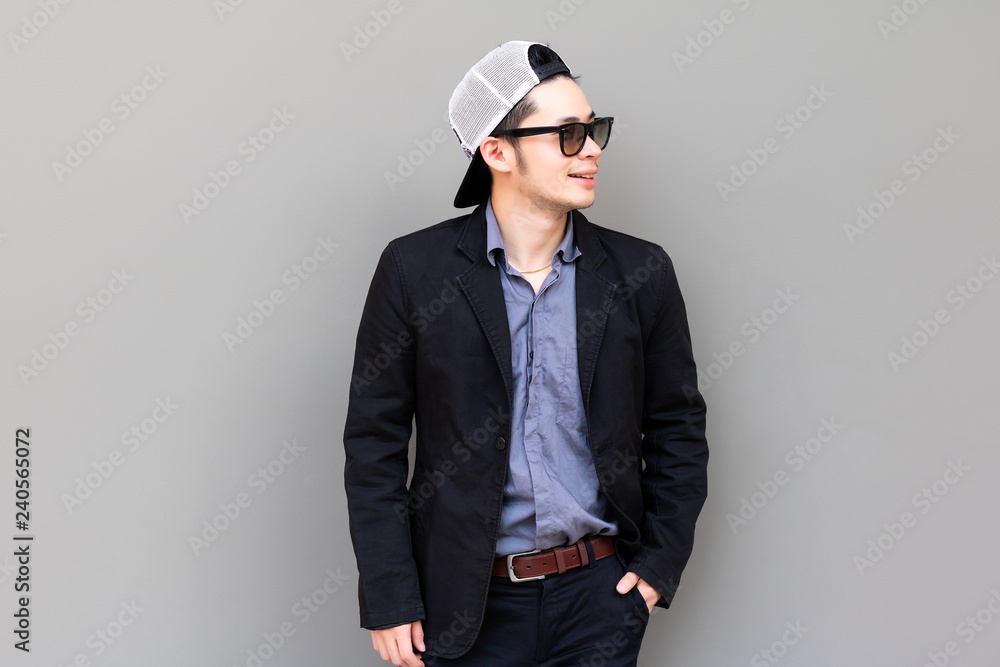 Portrait attractive handsome young businessman. Charming businessman is looking something that make him smile, happy and satisfy. Cool guy wears suit, hat, sunglasses. Glamour young man has nice smile Portrait attractive handsome young businessman. Charming businessman is looking something that make him smile, happy and satisfy. Cool guy wears suit, hat, sunglasses. Glamour young man has nice smile