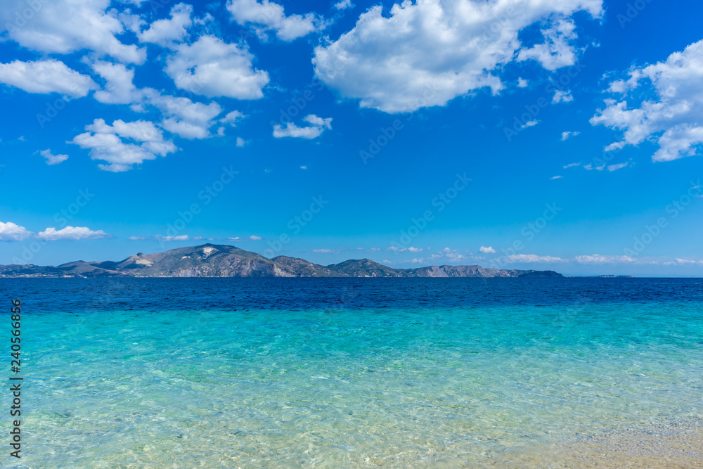 Greece, Zakynthos, Ideal azure blue clean water at sand beach with view on Zante island from Marathonissi Greece, Zakynthos, Ideal azure blue clean water at sand beach with view on Zante island from Marathonissi